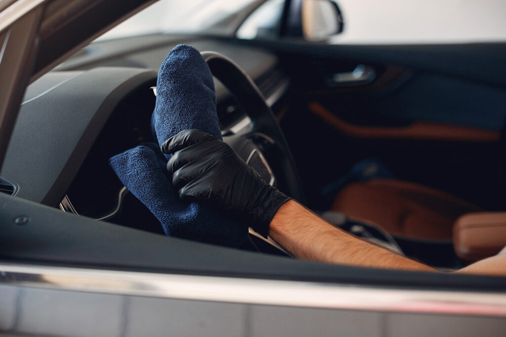 Man washing his car in a garage