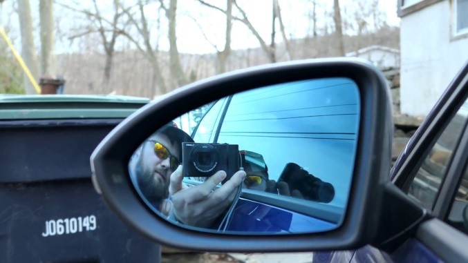 Guarantee that it is safely folded over your hands. Then, slide it to the rear of the blind spot mirror.  
